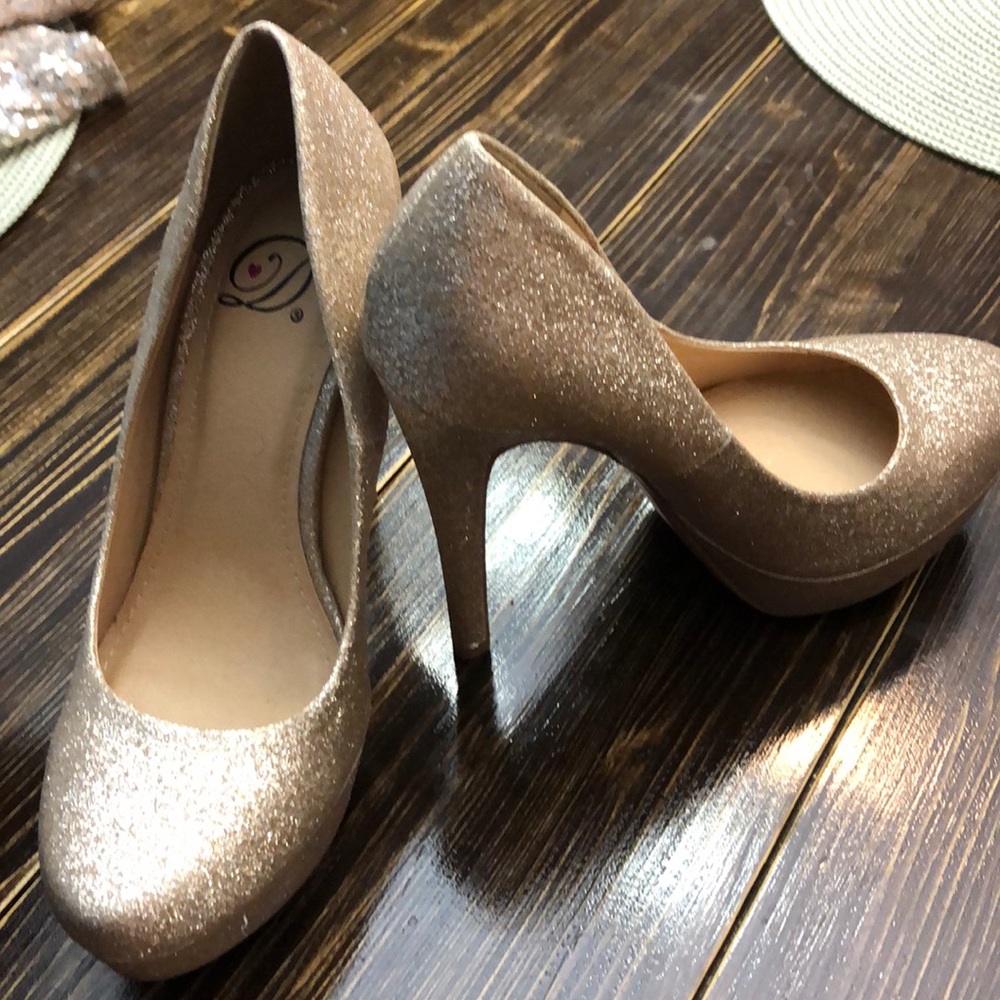 Gold high heeled shoes